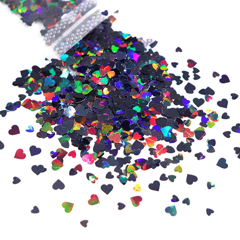 A pile of shiny holographic star sequins in various colors like pink, green, and blue.