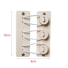 A wooden Montessori busy board with four circular holes for stringing white cord parts.