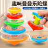 A hand is holding a colorful, multi-layered spinning top toy with various vibrant colors.