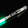 A silver lightsaber hilt with a glowing green blade is shown against a black background.