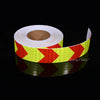Roll of high-visibility reflective safety tape with yellow and red chevron patterns