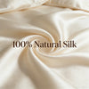 Close-up of smooth, cream-colored natural silk fabric draped in a soft swirl.