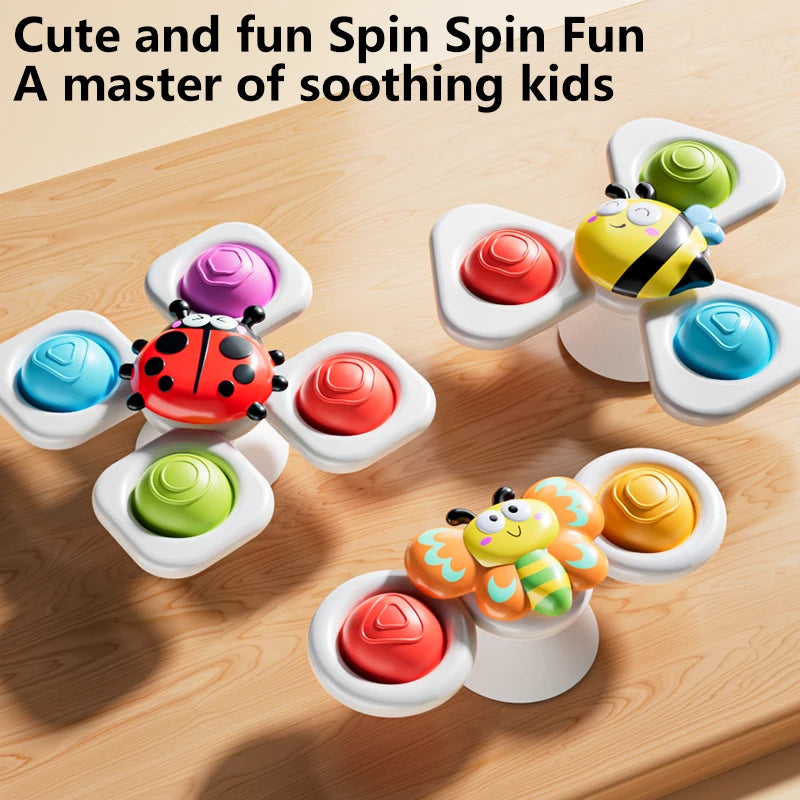 Three colorful spinning top fidget toys with watch bands are shown on a wooden surface.