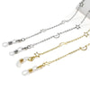 A delicate silver and gold chain featuring star and crescent moon pendants for glasses