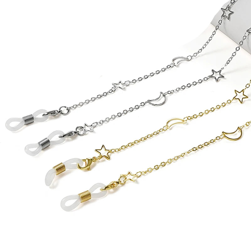 A delicate silver and gold chain featuring star and crescent moon pendants for glasses