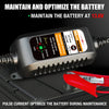 A black battery charger device is shown with a red clamp, used to maintain and optimize a 12V battery.