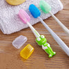 A set of colorful silicone toothbrush heads and a white brush handle are displayed on a gray towel.