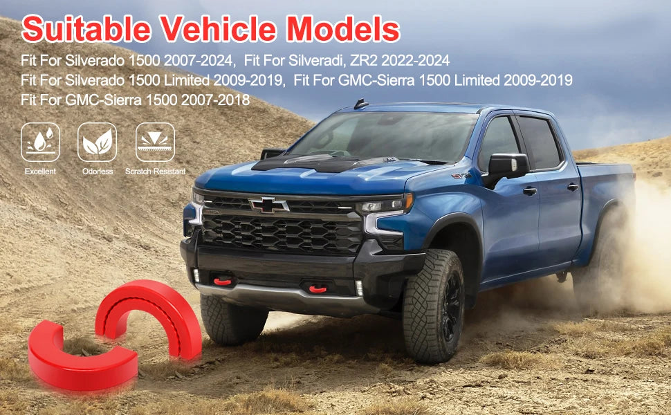 A blue Chevrolet Silverado pickup truck is driving on a dirt road, with red silicone tow hook covers visible in the foregroun