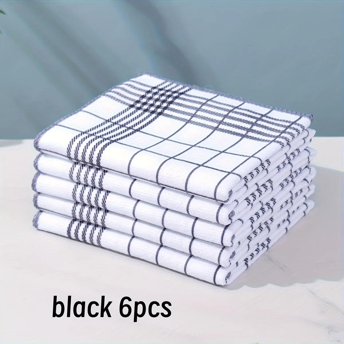A stack of six black and white checkered lint-free dish cloths or kitchen towels.