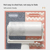 A roll of white microfiber cleaning rags displayed on a white rack against a background of gray and coral textured fabrics.