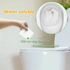 A hand is placing a water soluble disposable toilet seat cover into a toilet bowl, demonstrating its ability to prevent clogg