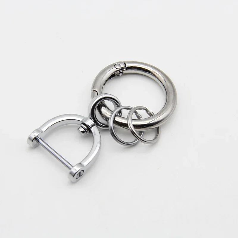 Silver metal key fob cover with a split ring and a loop for a Nissan car key.