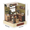 A DIY miniature Japanese sakura tea house wooden kit featuring a detailed interior with various items and an LED light.