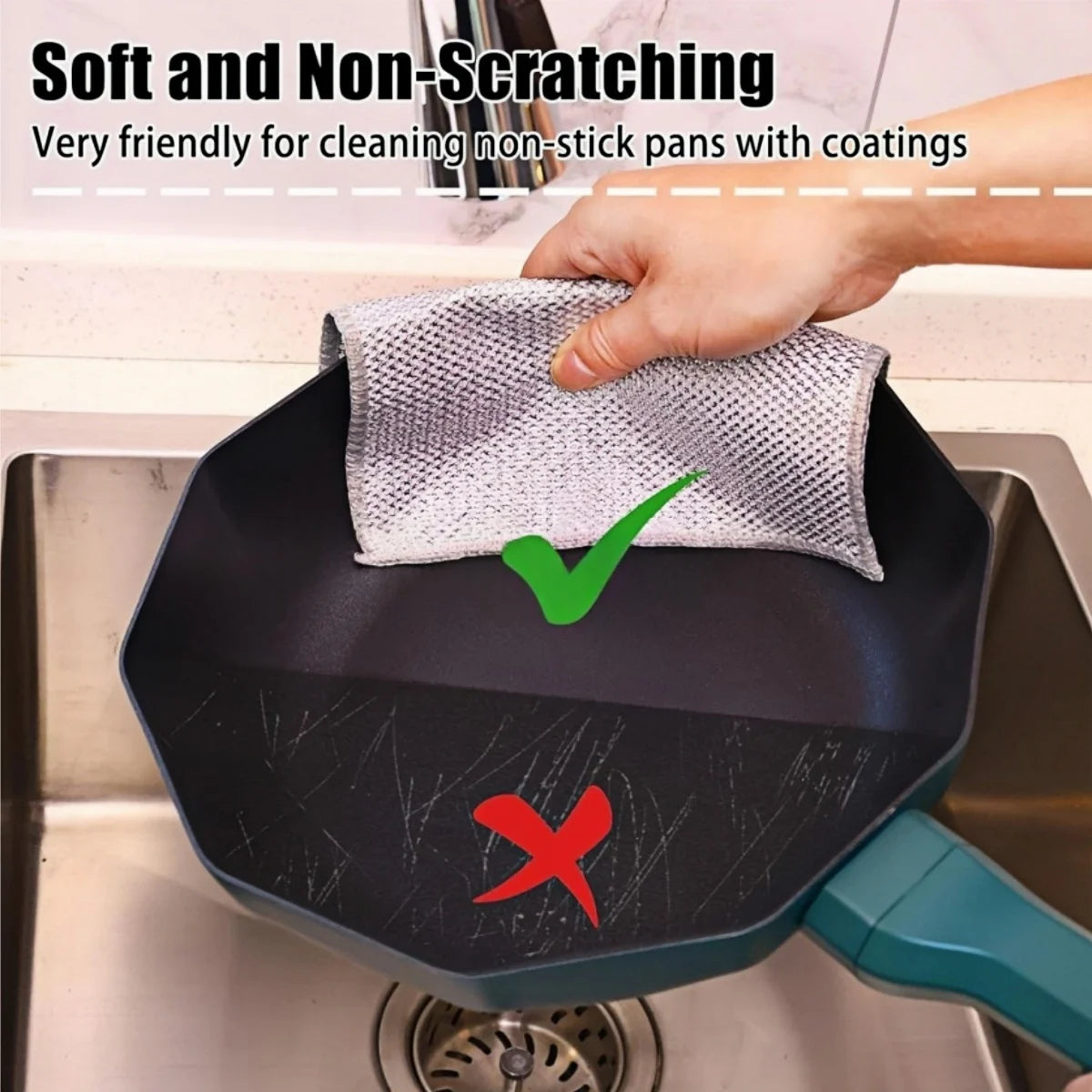 A hand is wiping a black non-stick pan with a gray scouring cloth, demonstrating the soft and non-scratching features.