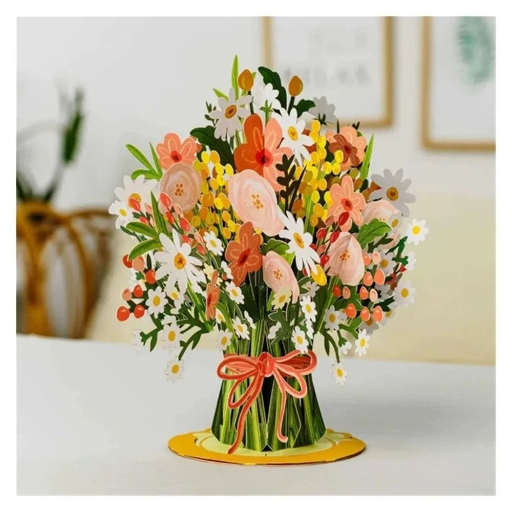 A vibrant bouquet of orange, pink, and white flowers arranged in a vase on a white surface.
