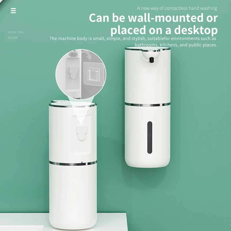 A white wall-mounted automatic soap dispenser is shown on a light green wall.