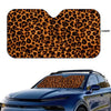 A leopard print car windshield sunshade applied to a blue car.