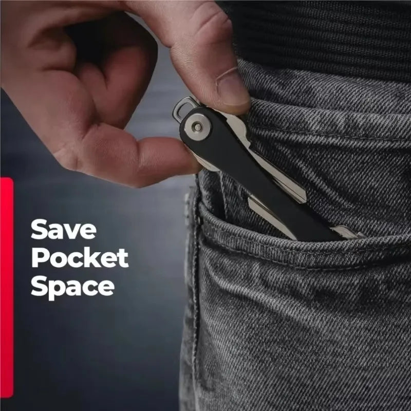 A hand is shown inserting an aluminum key clip with a carabiner hook into a pocket of jeans.
