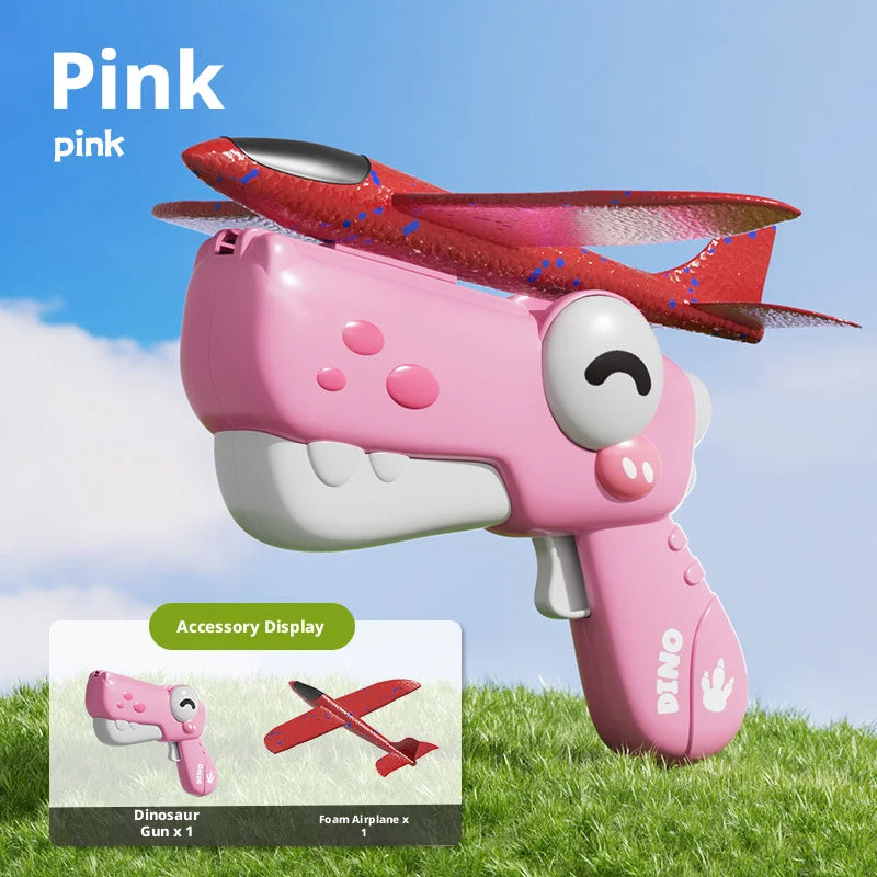 Pink Dino Gun accessory display showing a pink dinosaur gun and a red foam airplane.