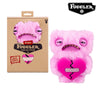 A pink Fuggler Ugly Monster plush toy with funny teeth and a heart design.