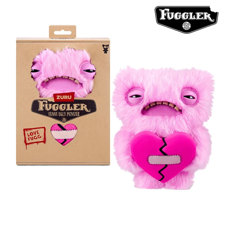 A pink Fuggler Ugly Monster plush toy with funny teeth and a heart design.