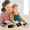 A woman and a girl are using a rainbow scratch art paper set with wooden stylus on a wooden table.