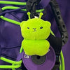 A bright lime green alien plush keychain with antennae is attached to a purple strap and key ring.