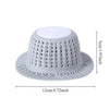 White collapsible silicone drain hair catcher with a perforated dome and wide base.