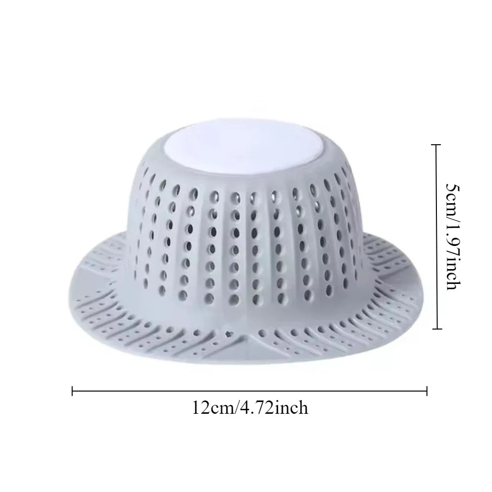 White collapsible silicone drain hair catcher with a perforated dome and wide base.