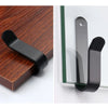 Black sturdy snowboard wall mount clips with screws shown against a white background.