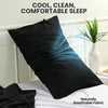 A black pillow is shown on a white bed with natural light, emphasizing cool, clean, and comfortable sleep.