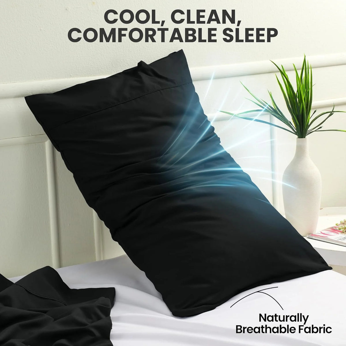 A black pillow is shown on a white bed with natural light, emphasizing cool, clean, and comfortable sleep.