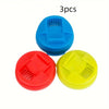 Three colorful reusable beverage can lids in blue, red, and yellow.