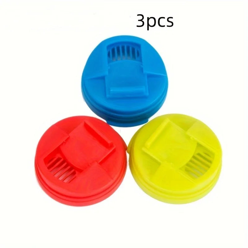 Three colorful reusable beverage can lids in blue, red, and yellow.