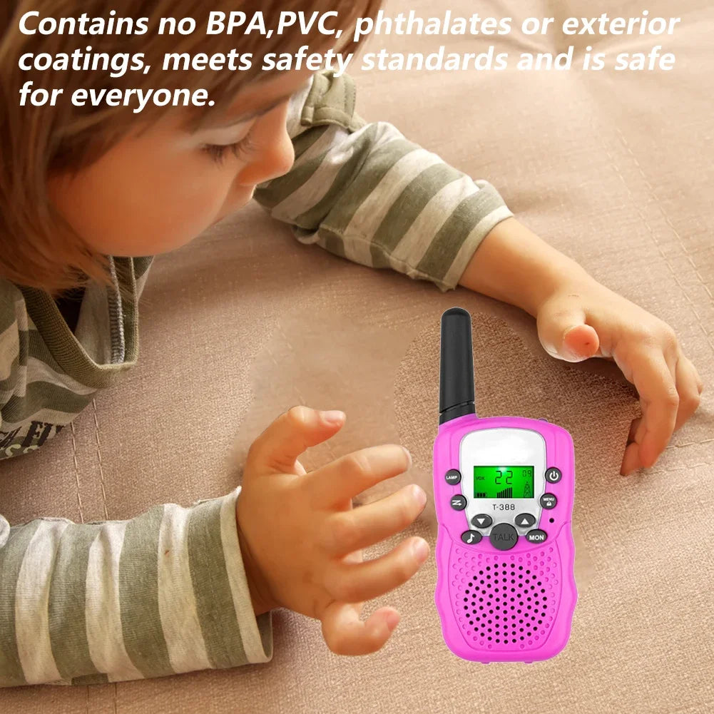 A child is holding a pink walkie talkie set with a flashlight, demonstrating its use.