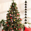 A decorated Christmas tree with ornaments and ribbons used as a backdrop for a vintage iron wind chime.