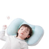 A baby is lying on a light blue reversible breathable pillow for support.