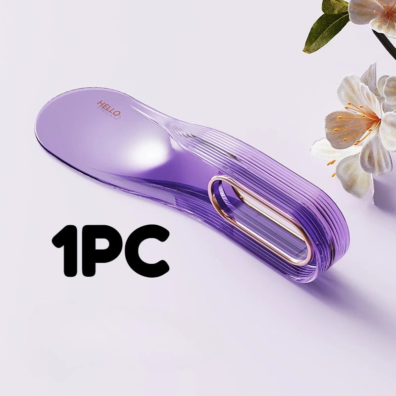 A single purple mattress lifter wedge tool is shown on a white surface next to a flower.