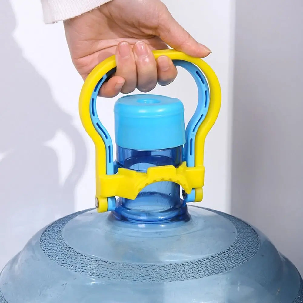 A hand is holding the yellow carry handle of a blue water bottle.