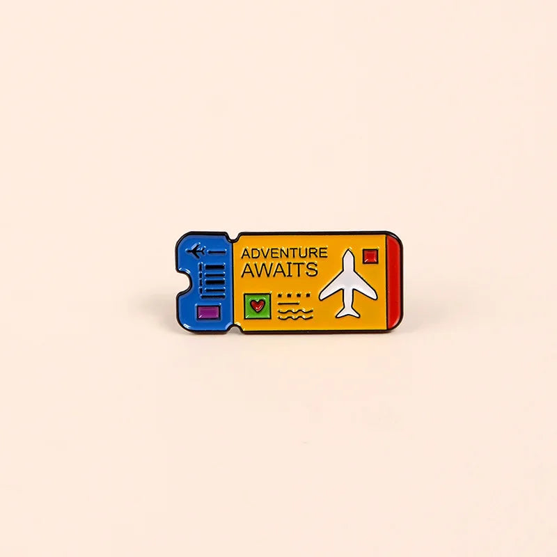 A vintage airline ticket enamel brooch set featuring an adventure awaits design with a plane and heart symbols.