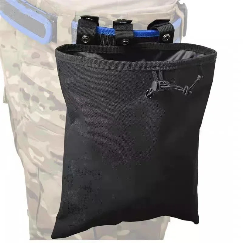 Black tactical MOLLE dump pouch with blue drawstring closure attached to a camouflage vest.