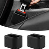 A close-up view of a black car seatbelt buckle protective cover being installed on a seatbelt, with two spare covers shown be