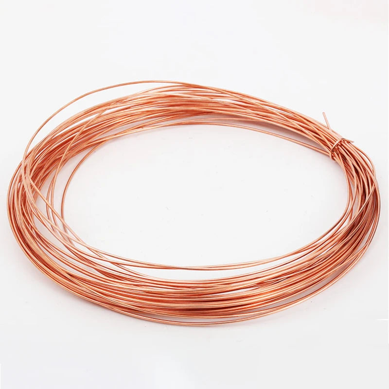 A coil of bare copper wire with multiple diameters laid out in a circular shape.
