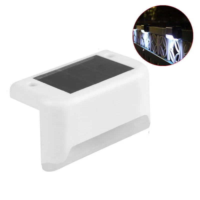 A white solar deck light with a dark panel and an inset showing illuminated LED step lights.