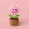 Handcrafted crochet pink sunflower growing in a brown felt pot