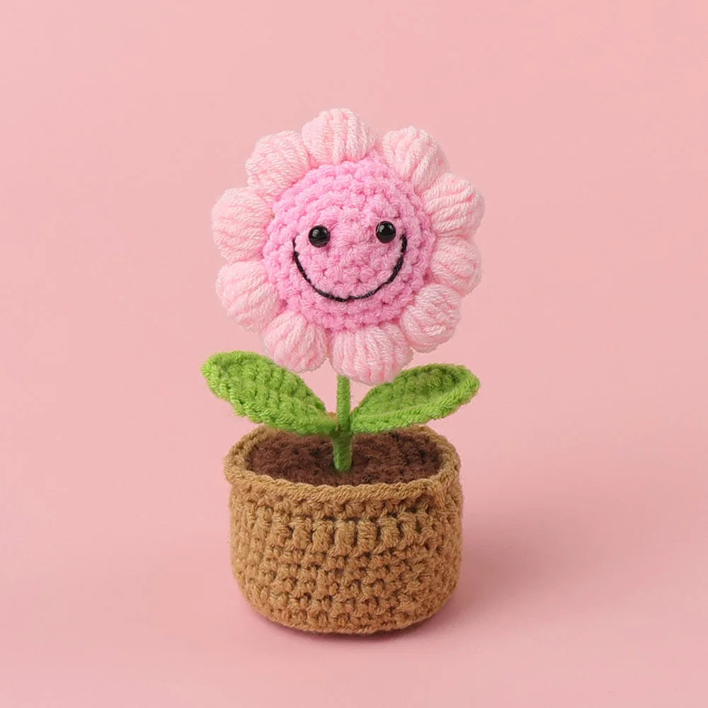 Handcrafted crochet pink sunflower growing in a brown felt pot