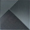 A close-up view of black, ribbed 3D diamond wall panels arranged in a sharp diagonal pattern.