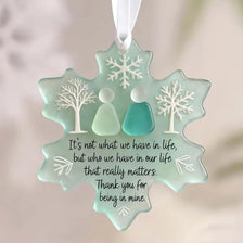 Handcrafted sea glass ornament shaped like a snowflake with frosted trees and a quote about relationships