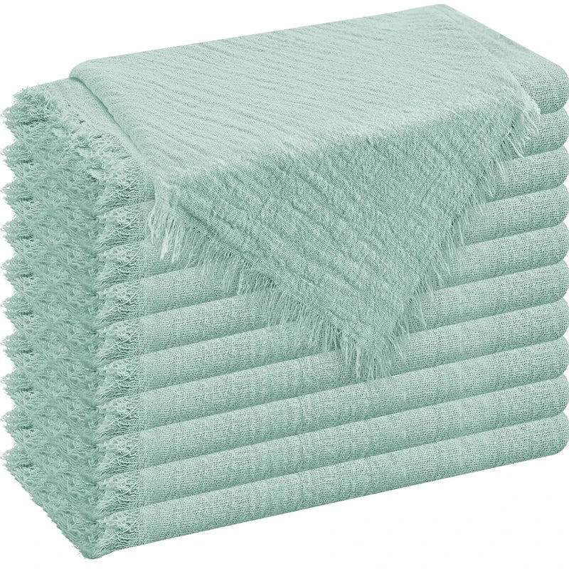 A stack of light mint green raw-edge polyester cloth napkins.