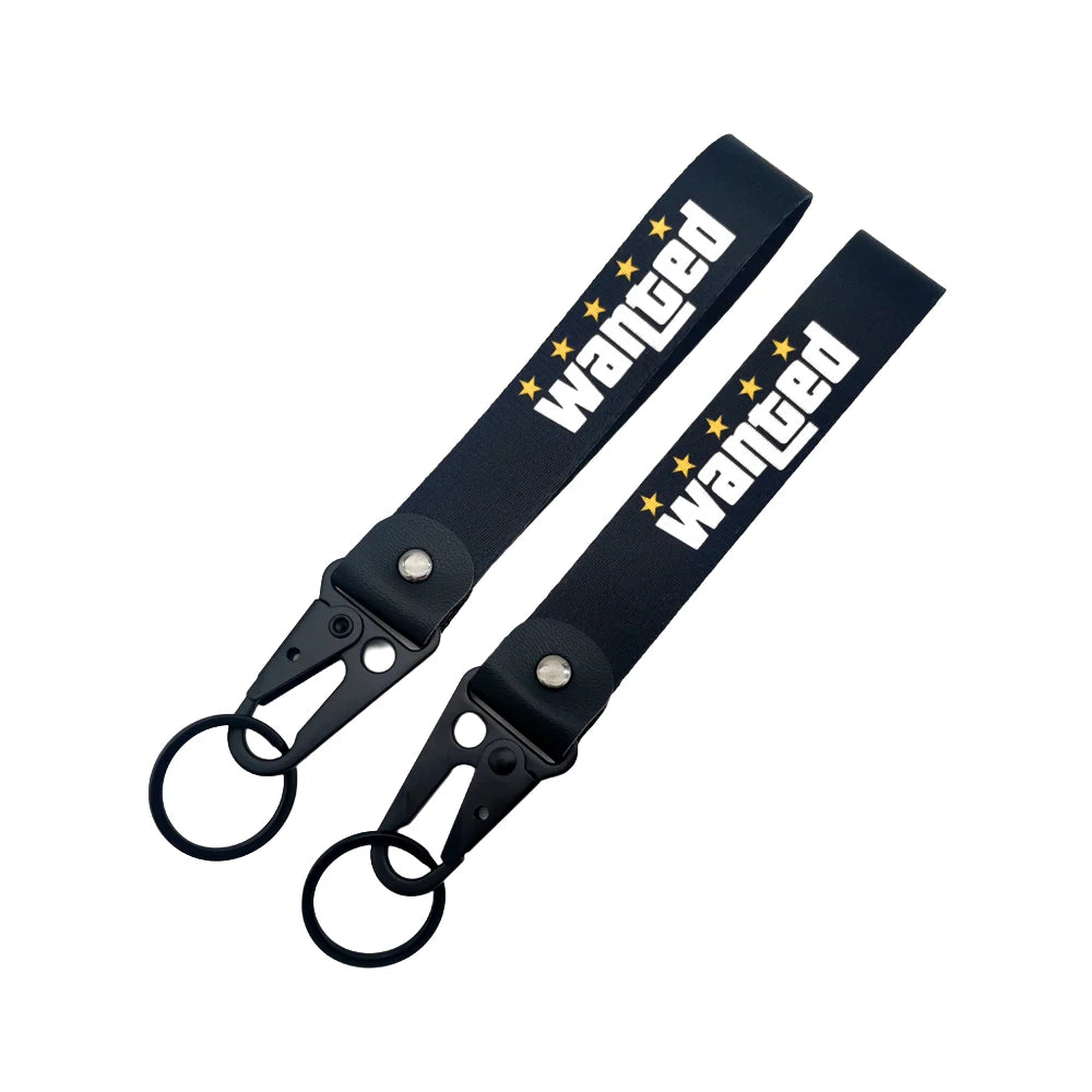 Black nylon keychain with embroidered wanted text and a steel spring clip